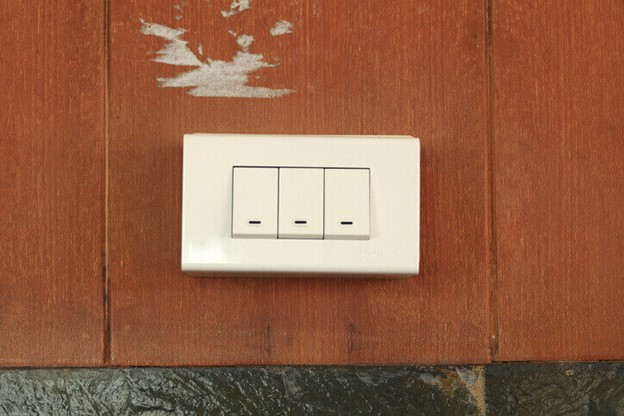 A white light switch was installed on a wooden wall in Frederick, MD
